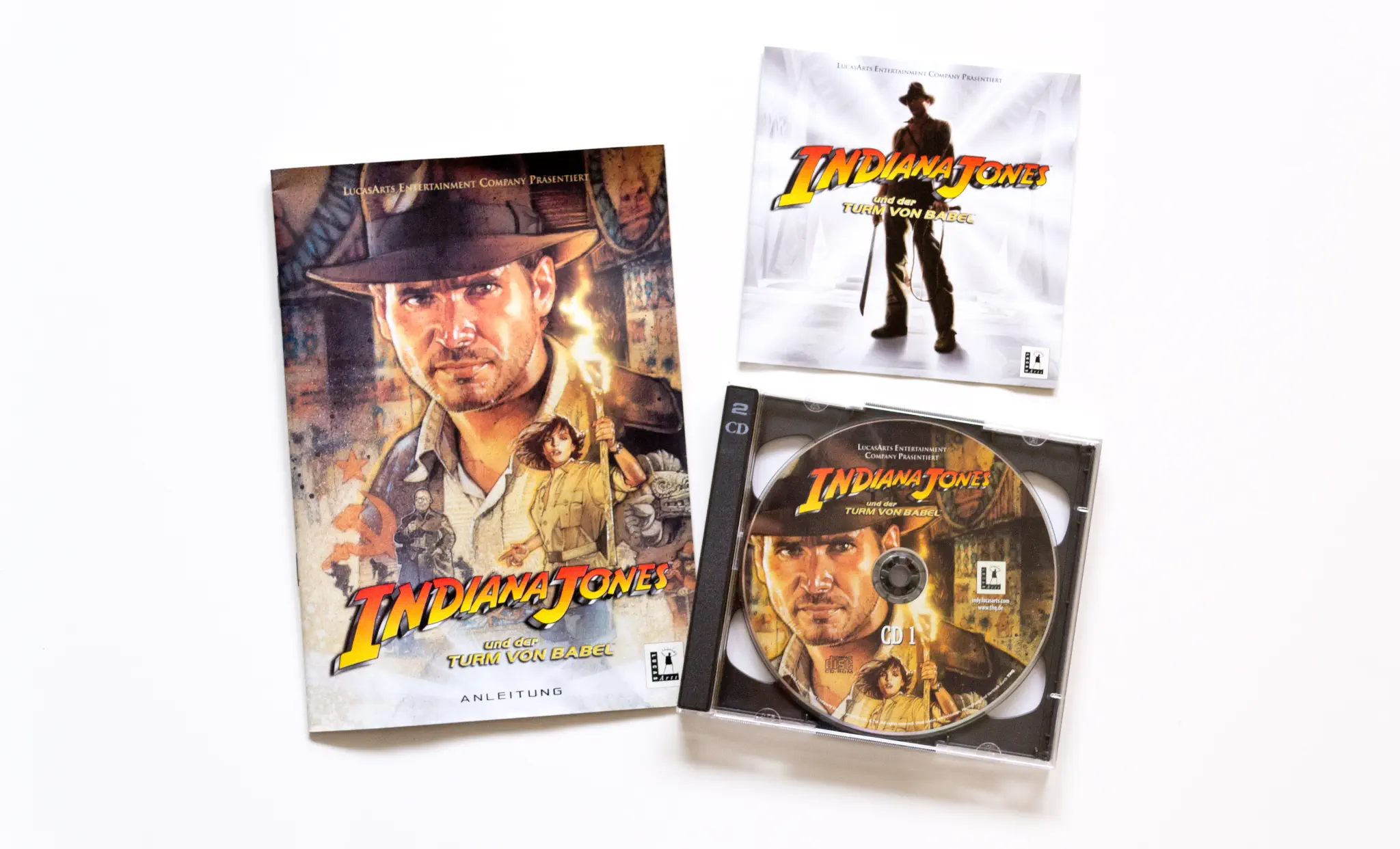 Photo of the content of Indiana Jones and the Infernal Machine (1999, PC, DE); developed by LucasArts Entertainment Company LLC, published by LucasArts Entertainment Company LLC; Hi-res 3D box available at https://bigboxcollection.com