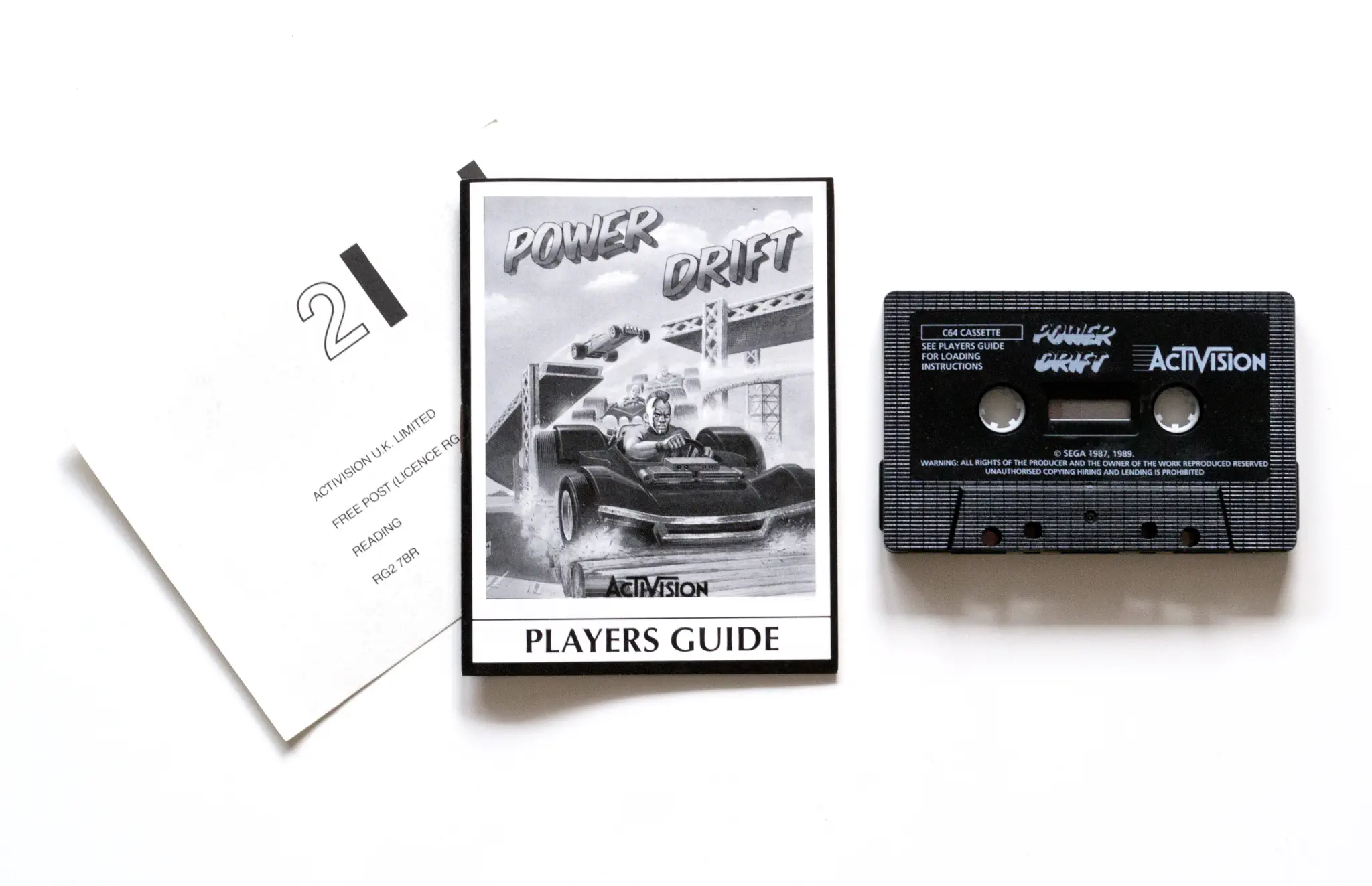 Photo of the content of Power Drift (1990, C64, EU); developed by SEGA Enterprises Ltd., published by Activision (UK) Limited; Hi-res 3D box available at https://bigboxcollection.com