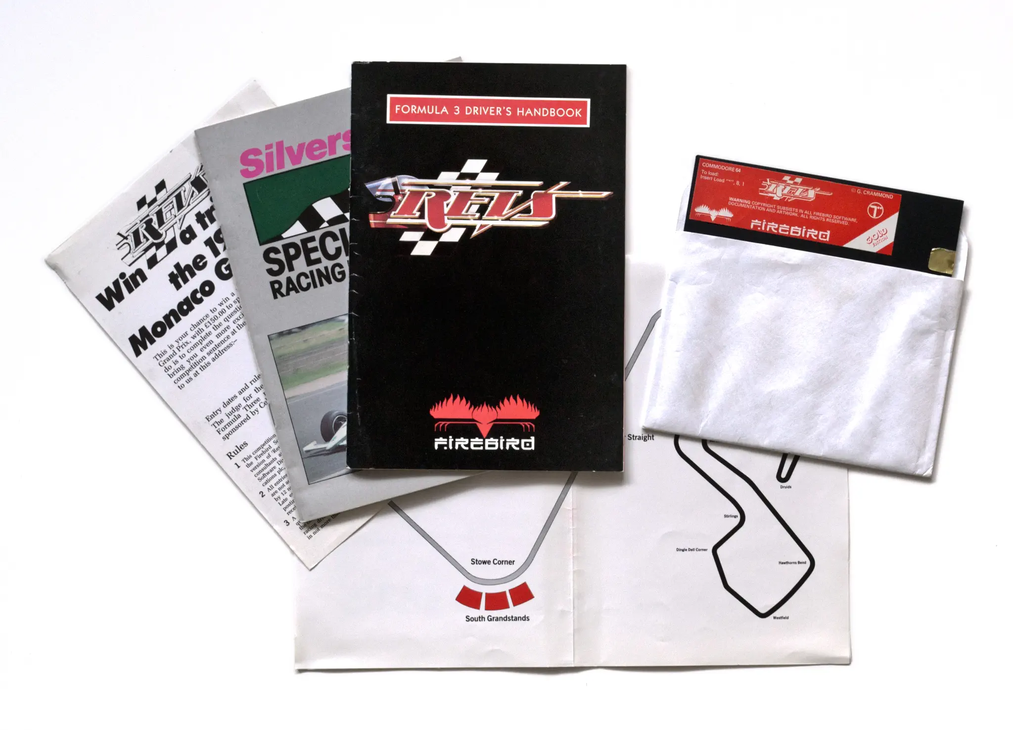 Photo of the content of Revs (1986, C64, UK, Gold Edition); developed by Geoffrey J. Crammond, published by Firebird Software; Hi-res 3D box available at https://bigboxcollection.com