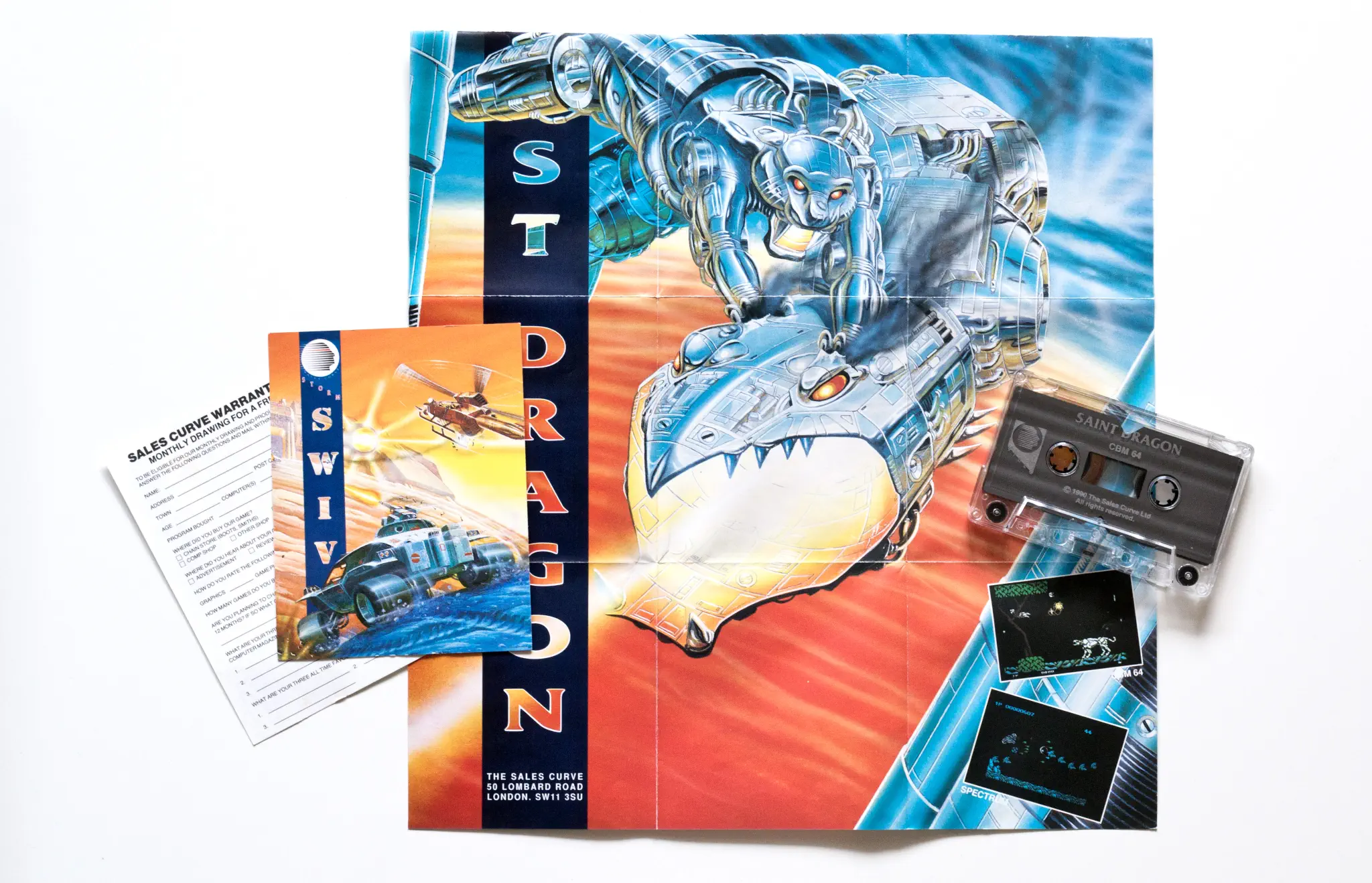 Photo of the content of Saint Dragon (1990, C64, EU); developed by NMK Co. Ltd., published by Storm; Hi-res 3D box available at https://bigboxcollection.com