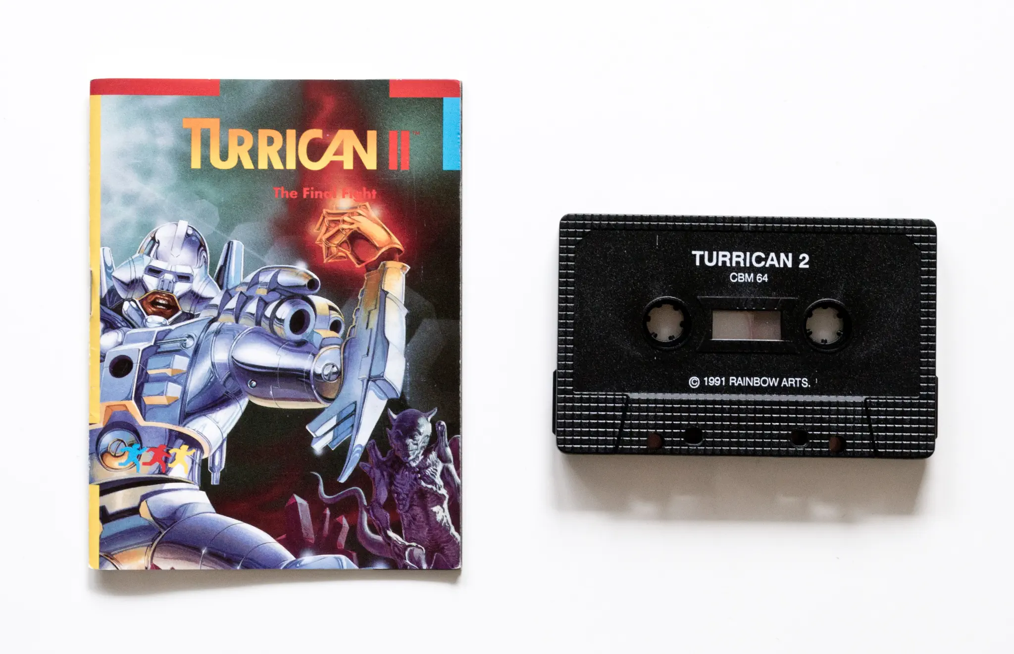 Photo of the content of Turrican II: The Final Fight (1991, C64, EU); developed by Factor 5 GmbH, published by Rainbow Arts Software GmbH; Hi-res 3D box available at https://bigboxcollection.com